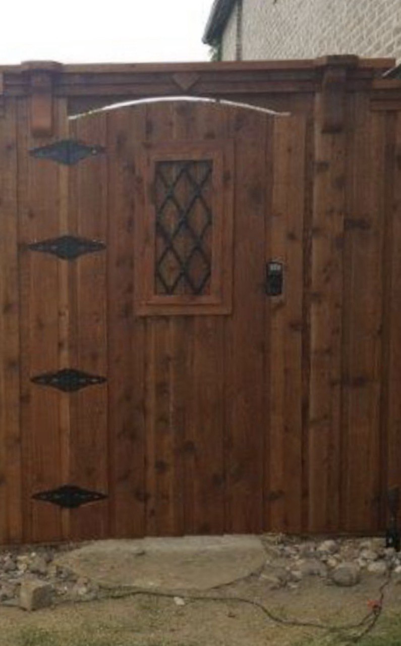 Custom designer wood gate with wrought iron diamond accents and arched cedar trim